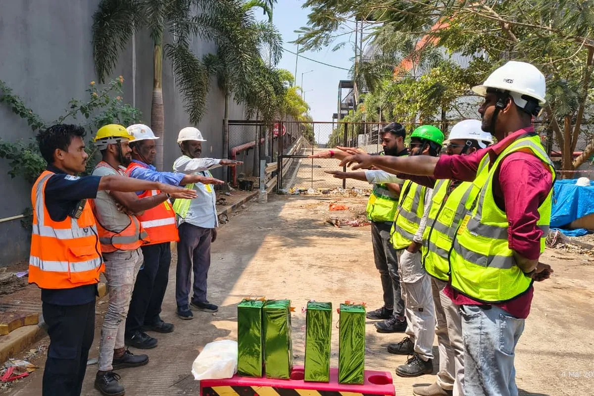 Site safety briefing with team in reflective vests and helmets